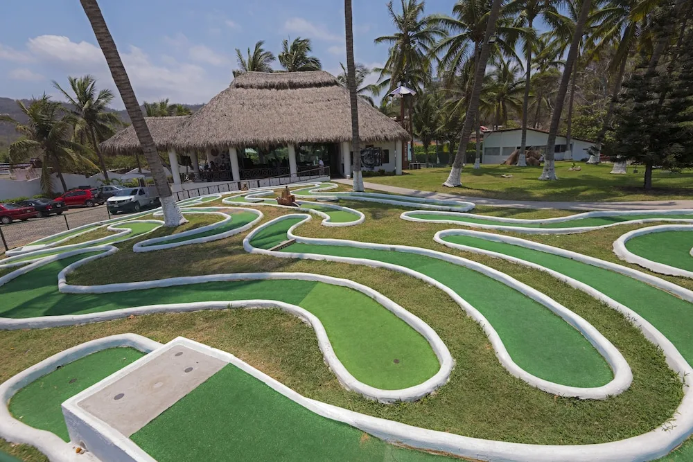 Mini golf course and thatched pavilion at Vista Playa de Oro Manzanillo.