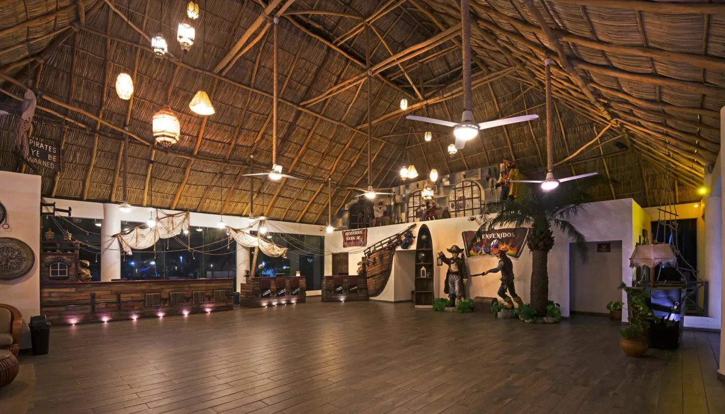 Pirate-themed open-air lobby with thatched roof at Vista Playa de Oro Manzanillo.