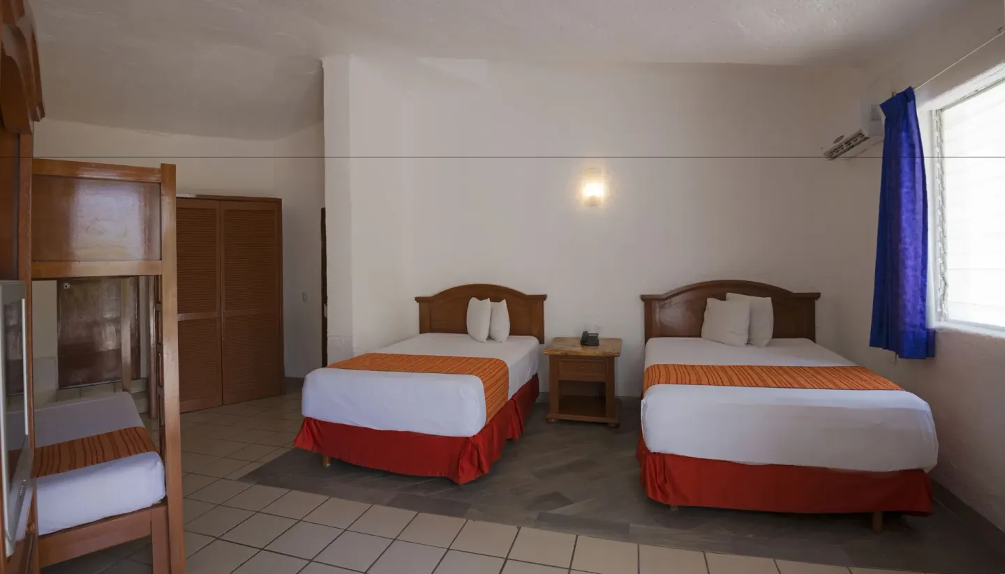 Family Room with two beds and bunk bed at Vista Playa de Oro Manzanillo.