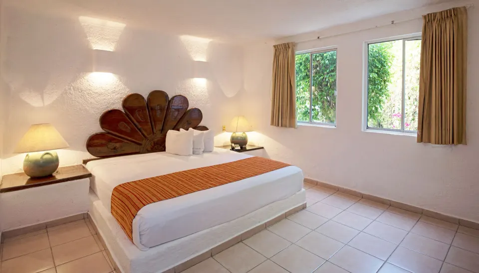 Standard Room with king bed and garden-facing windows at Vista Playa de Oro Manzanillo.