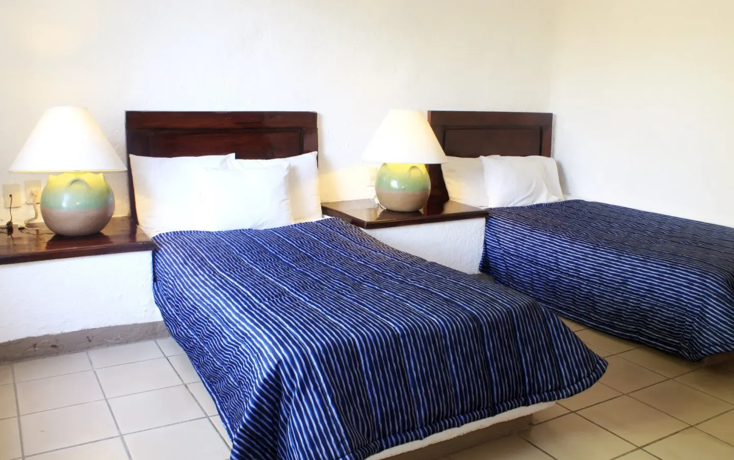Standard Room with two beds and blue striped covers at Vista Playa de Oro Manzanillo.