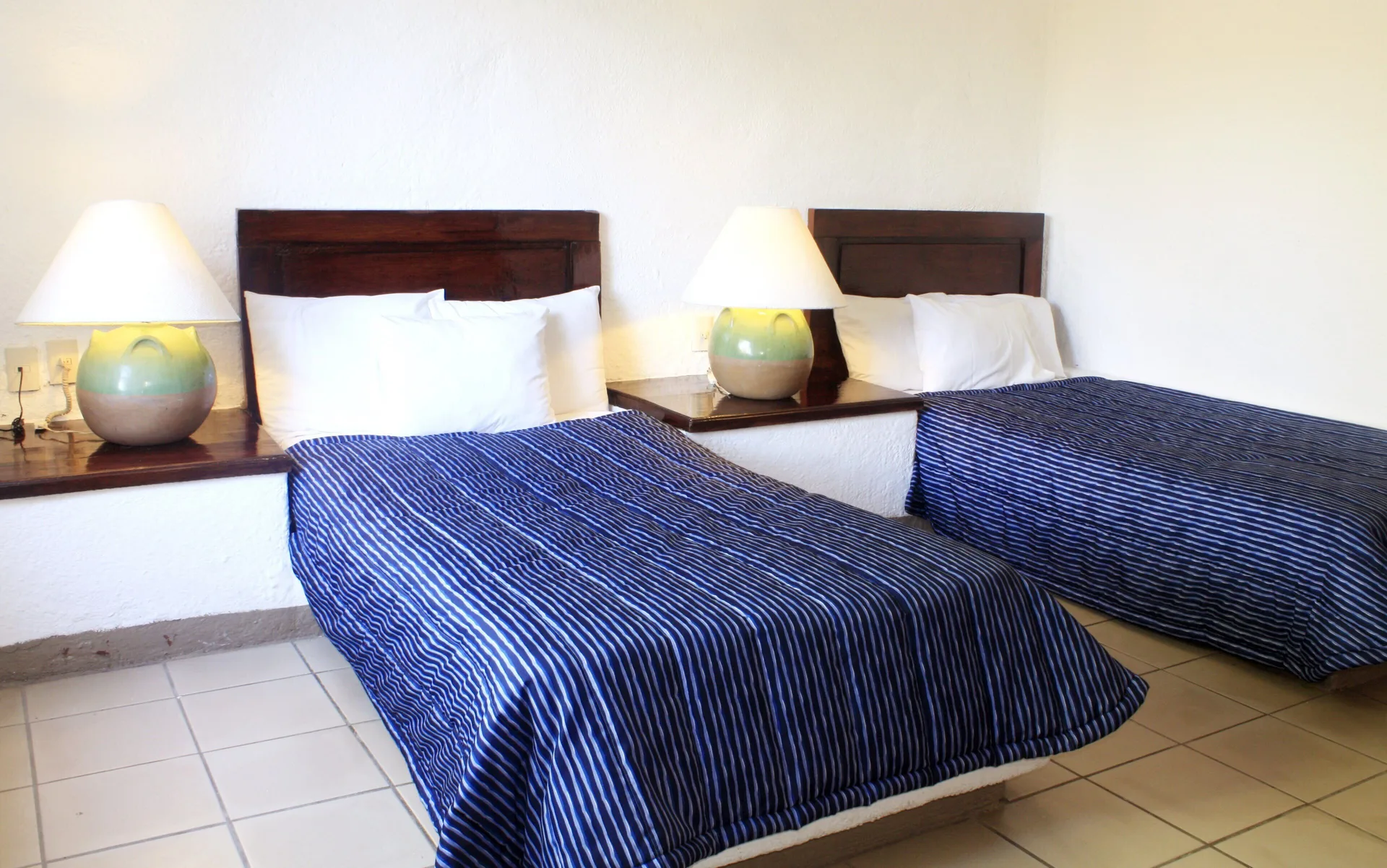 Standard Room with two beds and blue striped covers at Vista Playa de Oro Manzanillo.