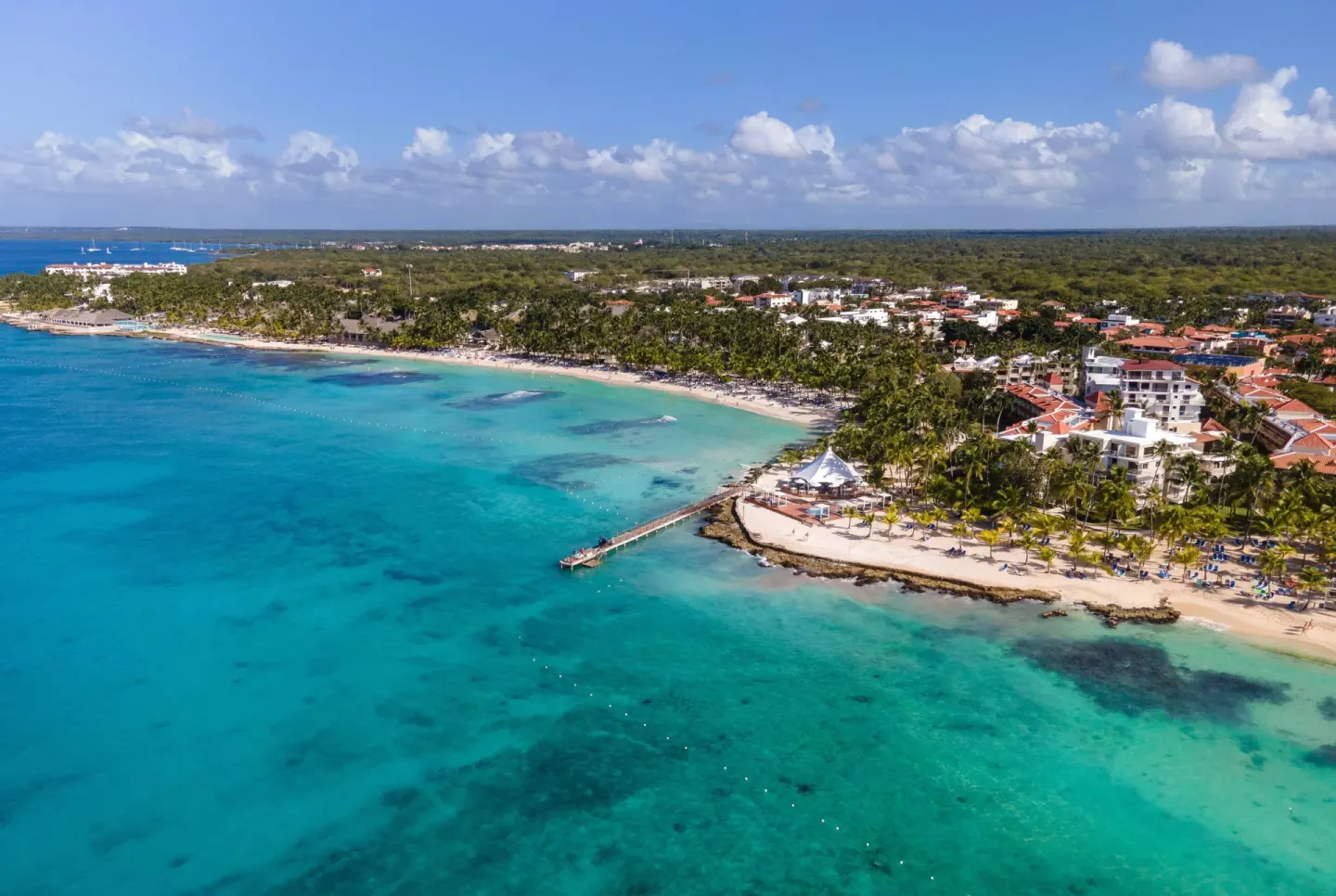 Aerial view of the beach, pier, and turquoise coastline at Viva Dominicus Palace.