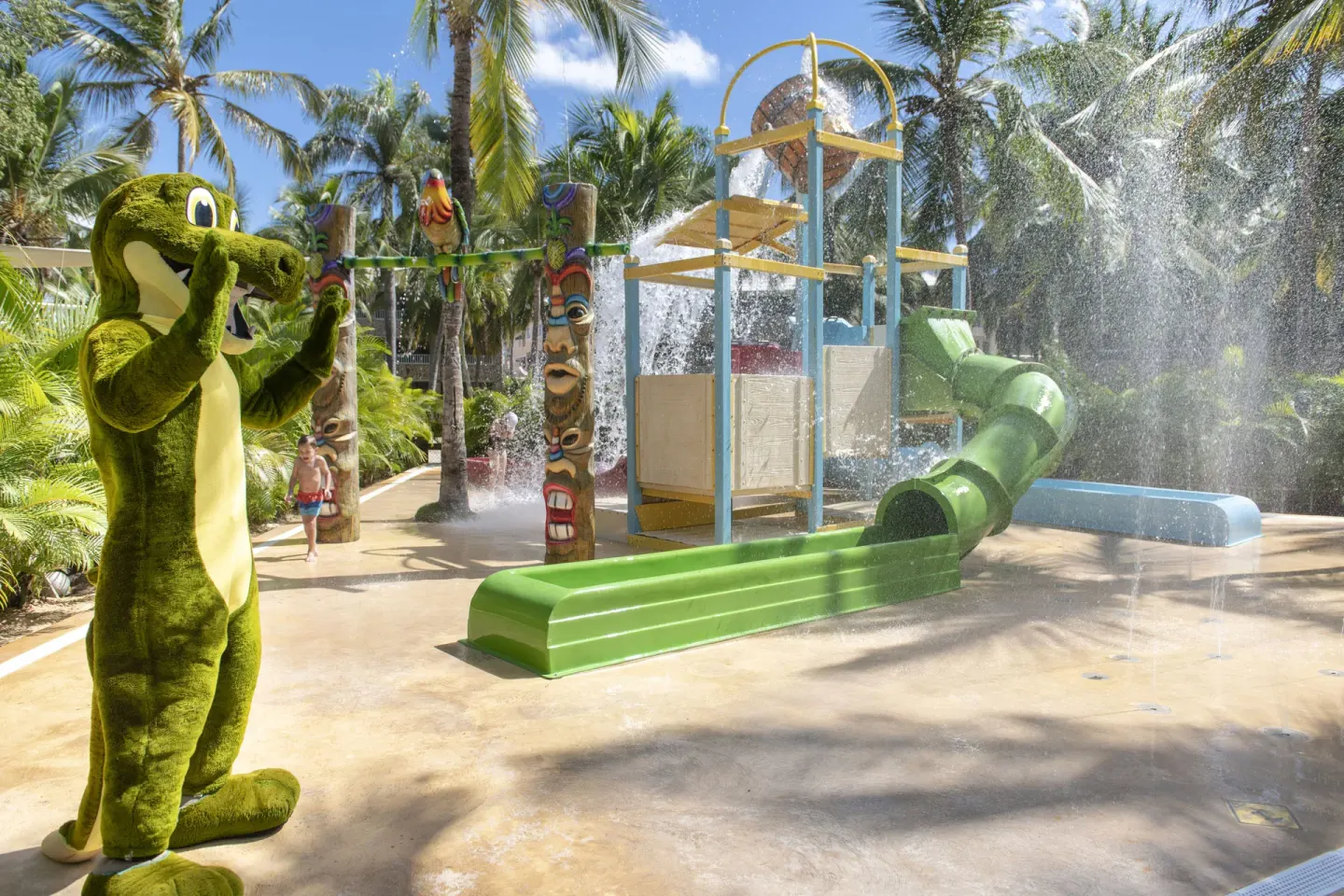 Mascot beside the children's splash play structure at Viva Dominicus Palace.