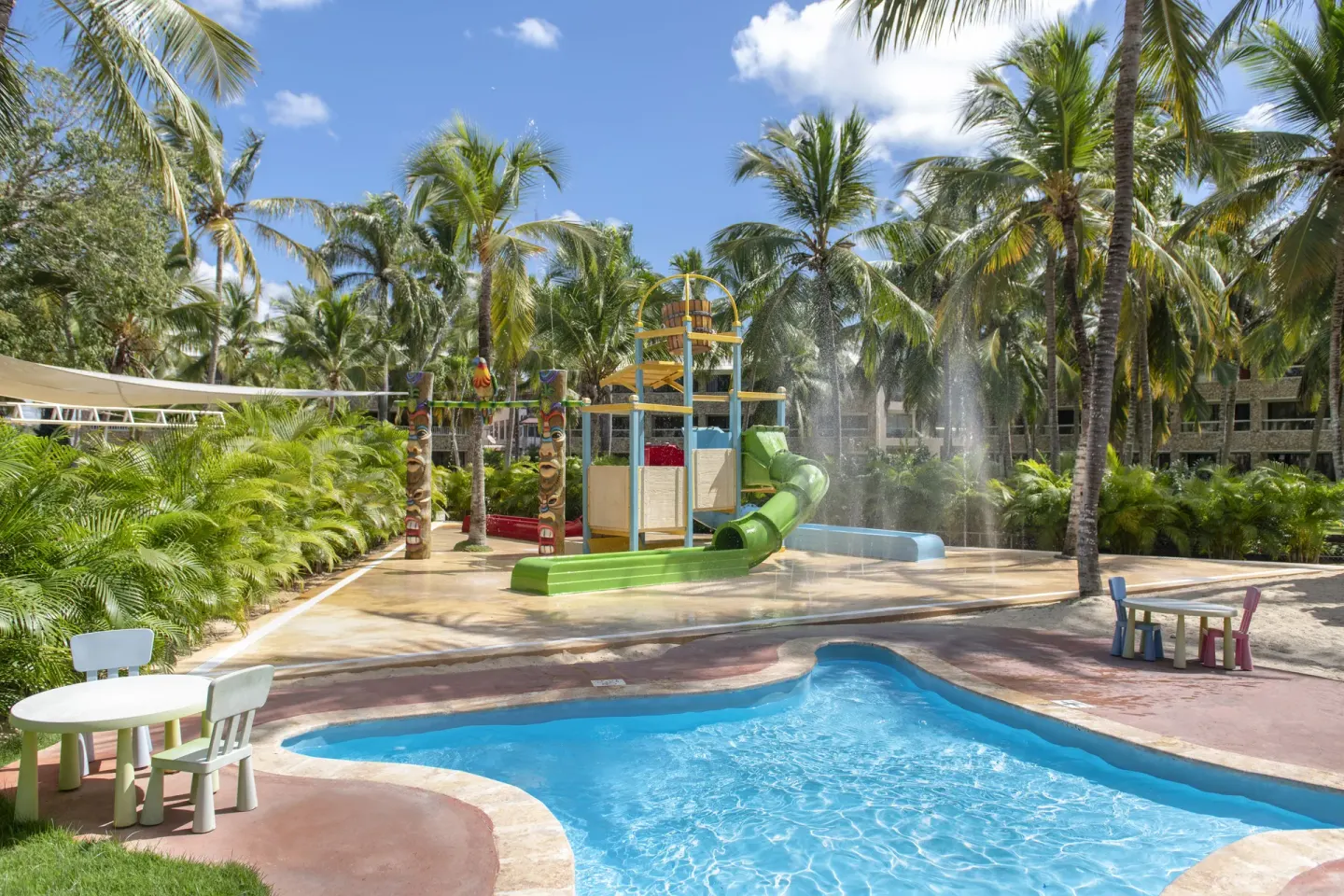Children's splash pool with slides and palms at Viva Dominicus Palace.