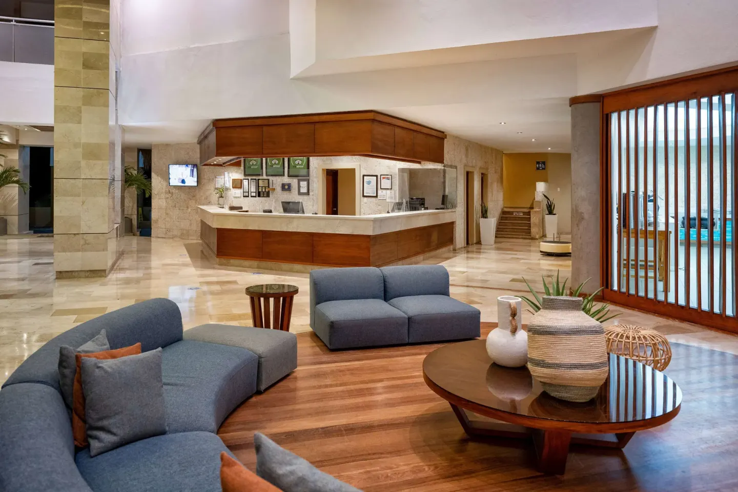 Lobby seating and reception desk with pool beyond at Viva Dominicus Palace.