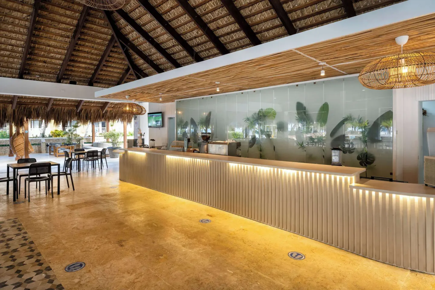 Open-air resort lobby with long illuminated reception counter at Viva Dominicus Palace.