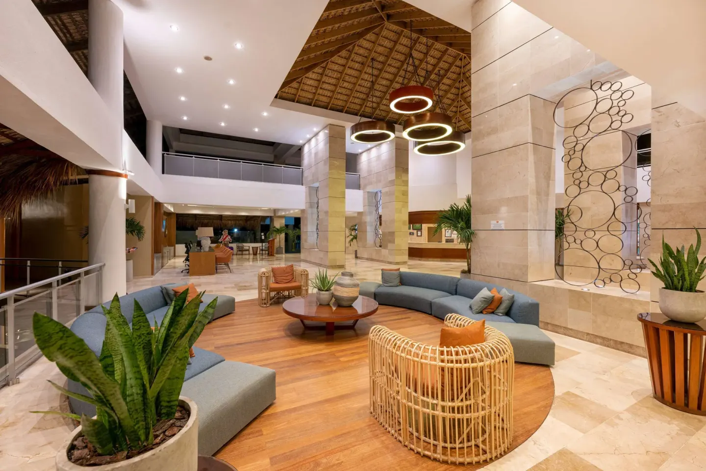 Open lobby lounge with circular seating and ring lights at Viva Dominicus Palace.