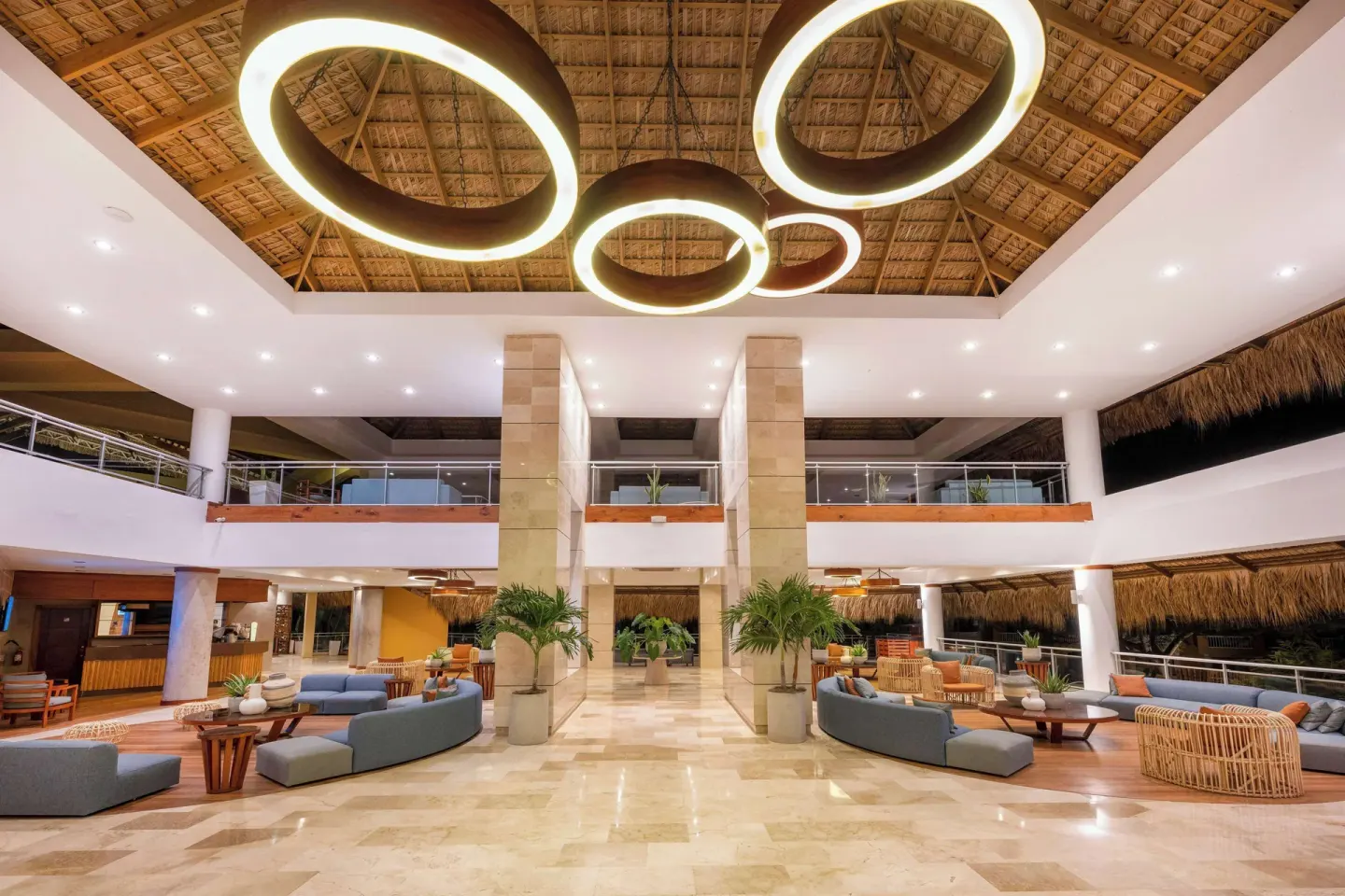 Spacious lobby atrium with sofas, columns, and ring lights at Viva Dominicus Palace.