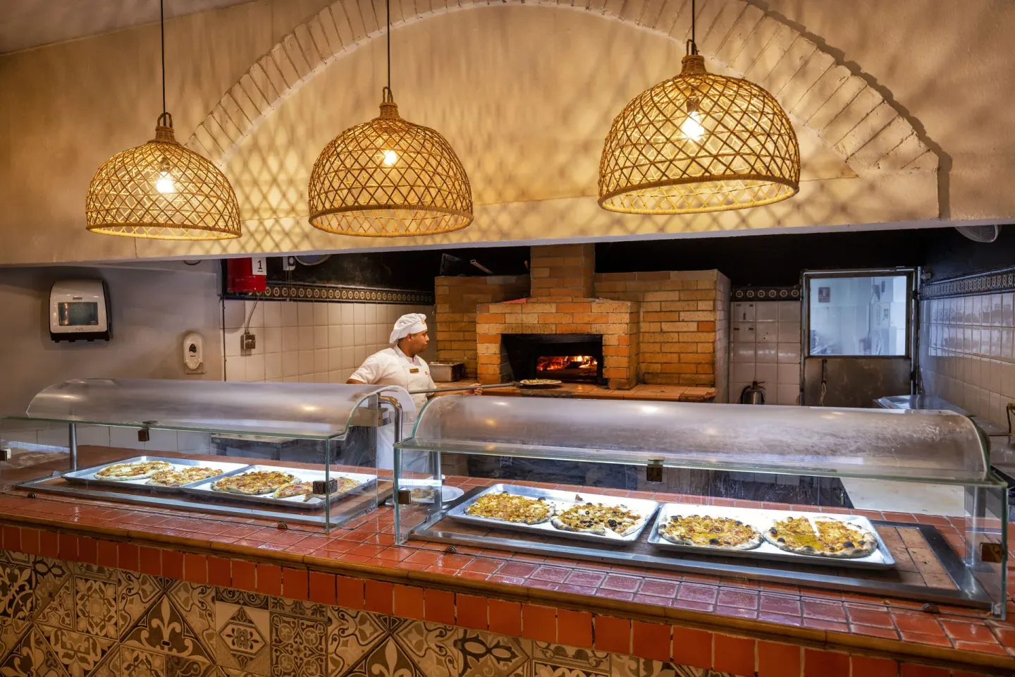 Pizza buffet counter with brick oven and chef at Viva Dominicus Palace.