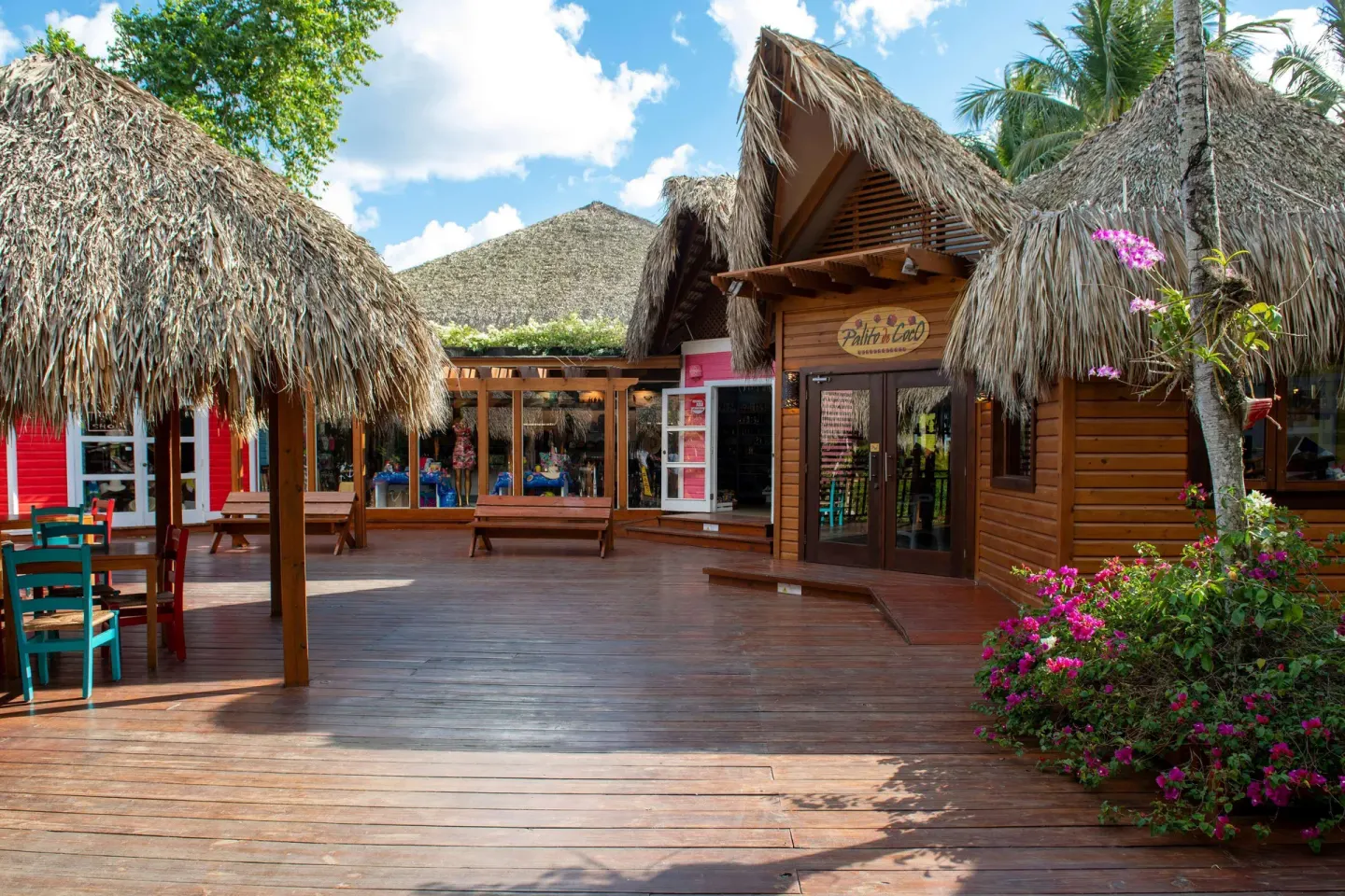 Palito de Coco entrance on a wooden deck with thatched roofs at Viva Dominicus Palace.