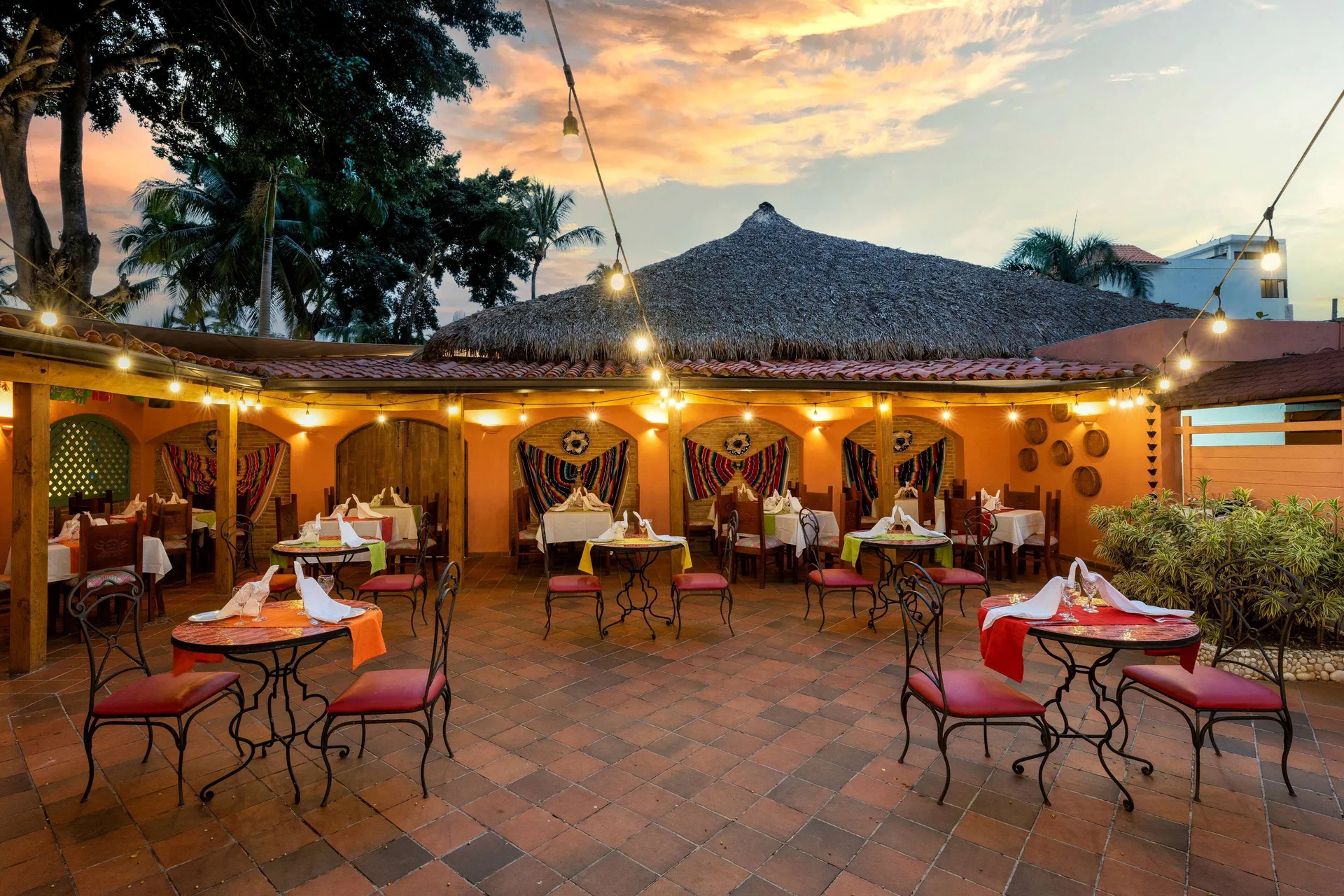 Courtyard restaurant with string lights and colorful textiles at Viva Dominicus Palace.
