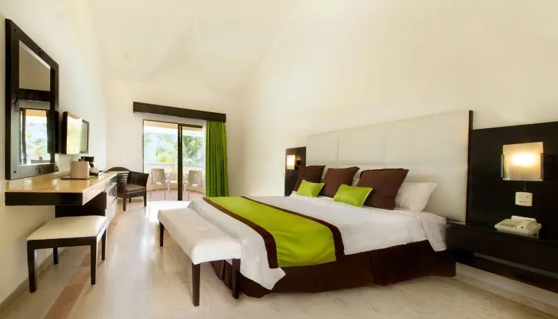 Superior room with king bed, seating area, and balcony at Viva Dominicus Palace.