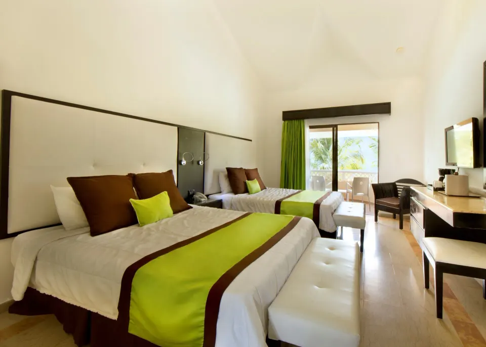 Superior Ocean View room with two beds, desk, and balcony at Viva Dominicus Palace.