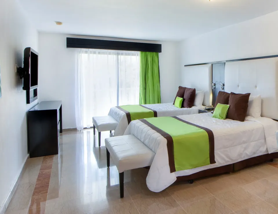 Superior Ocean View room with two beds and wall-mounted TV at Viva Dominicus Palace.