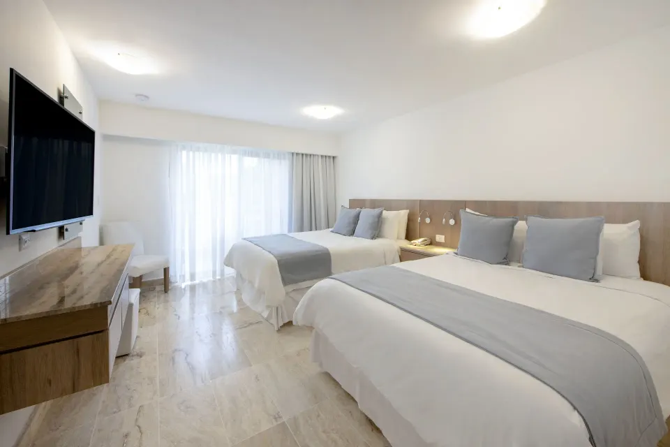 Superior Plus non-smoking room with two beds and wall-mounted TV at Viva Dominicus Palace.