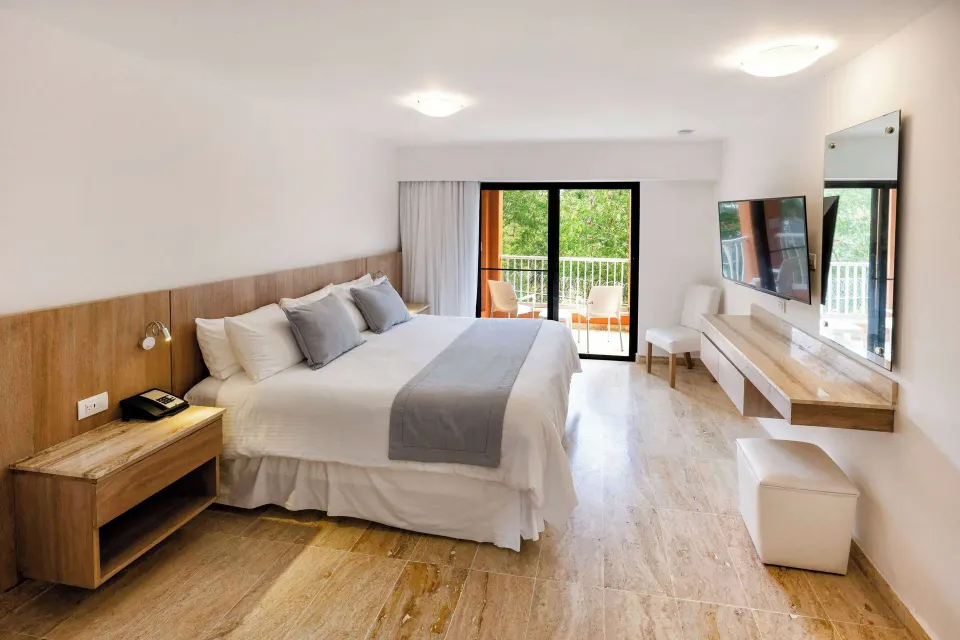 Superior Plus king room with balcony and greenery view at Viva Dominicus Palace.