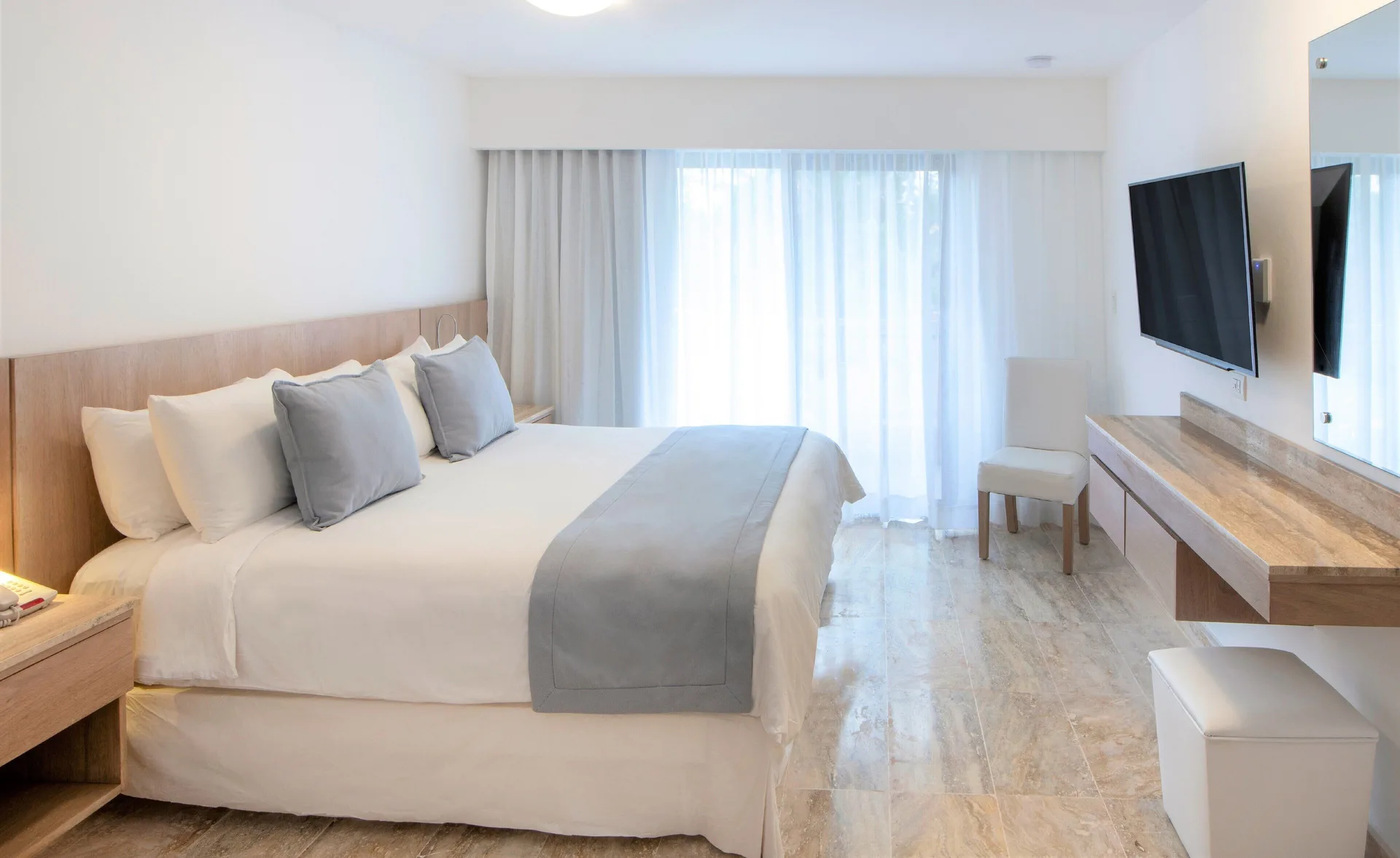 Superior Plus king room with vanity bench and sheer curtains at Viva Dominicus Palace.