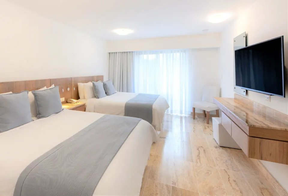 Superior Plus double-bed guest room with bright window light at Viva Dominicus Palace.