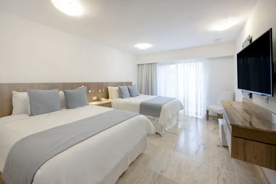 Superior Plus room with two double beds and TV console at Viva Dominicus Palace.