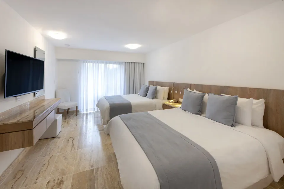 Superior Plus two-bed room with TV and curtained balcony door at Viva Dominicus Palace.