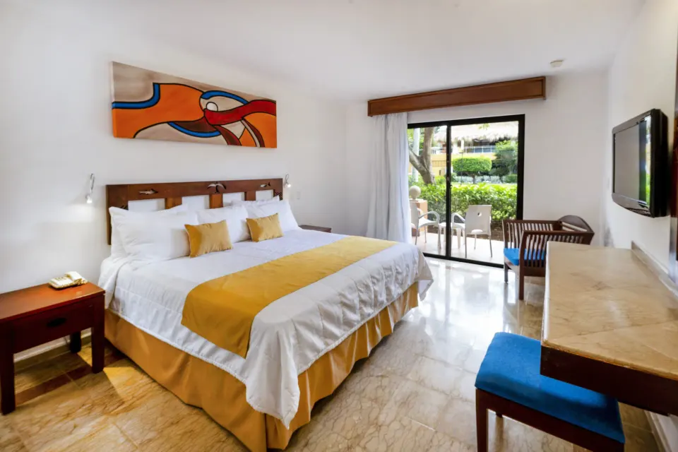 Superior non-smoking king room with artwork and patio doors at Viva Dominicus Palace.
