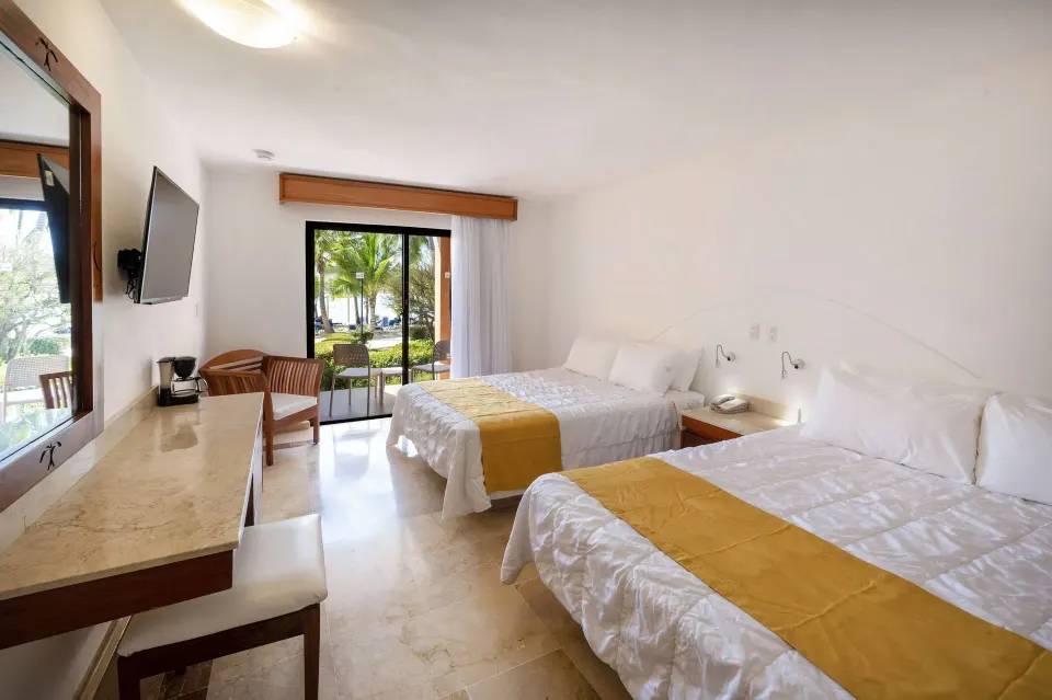 Superior non-smoking room with two beds, desk, and garden patio at Viva Dominicus Palace.