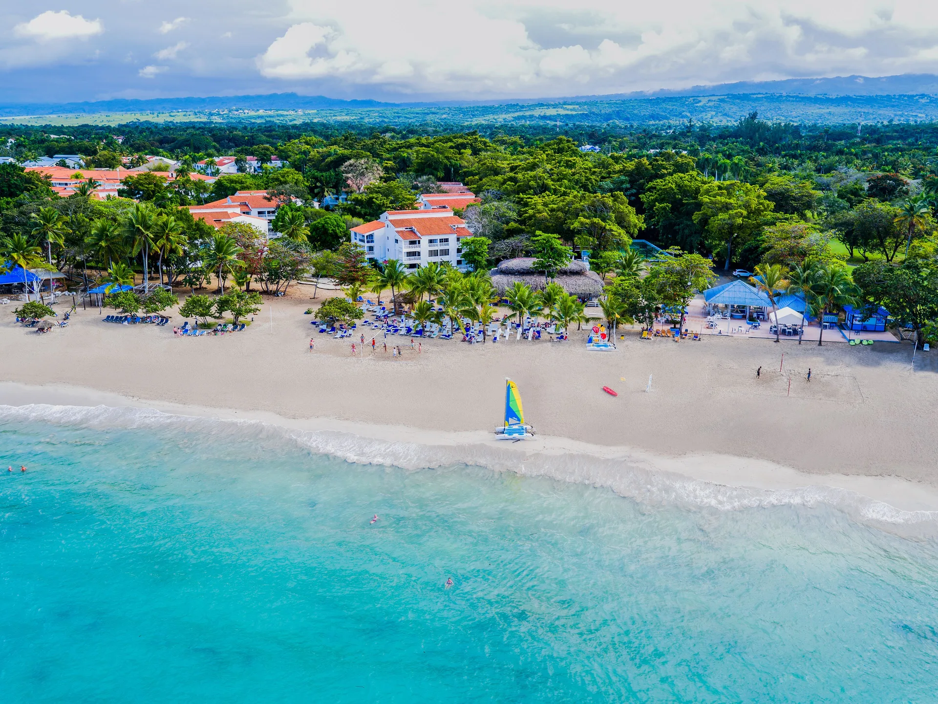 Aerial view of the beach and turquoise water at Viva Heavens.