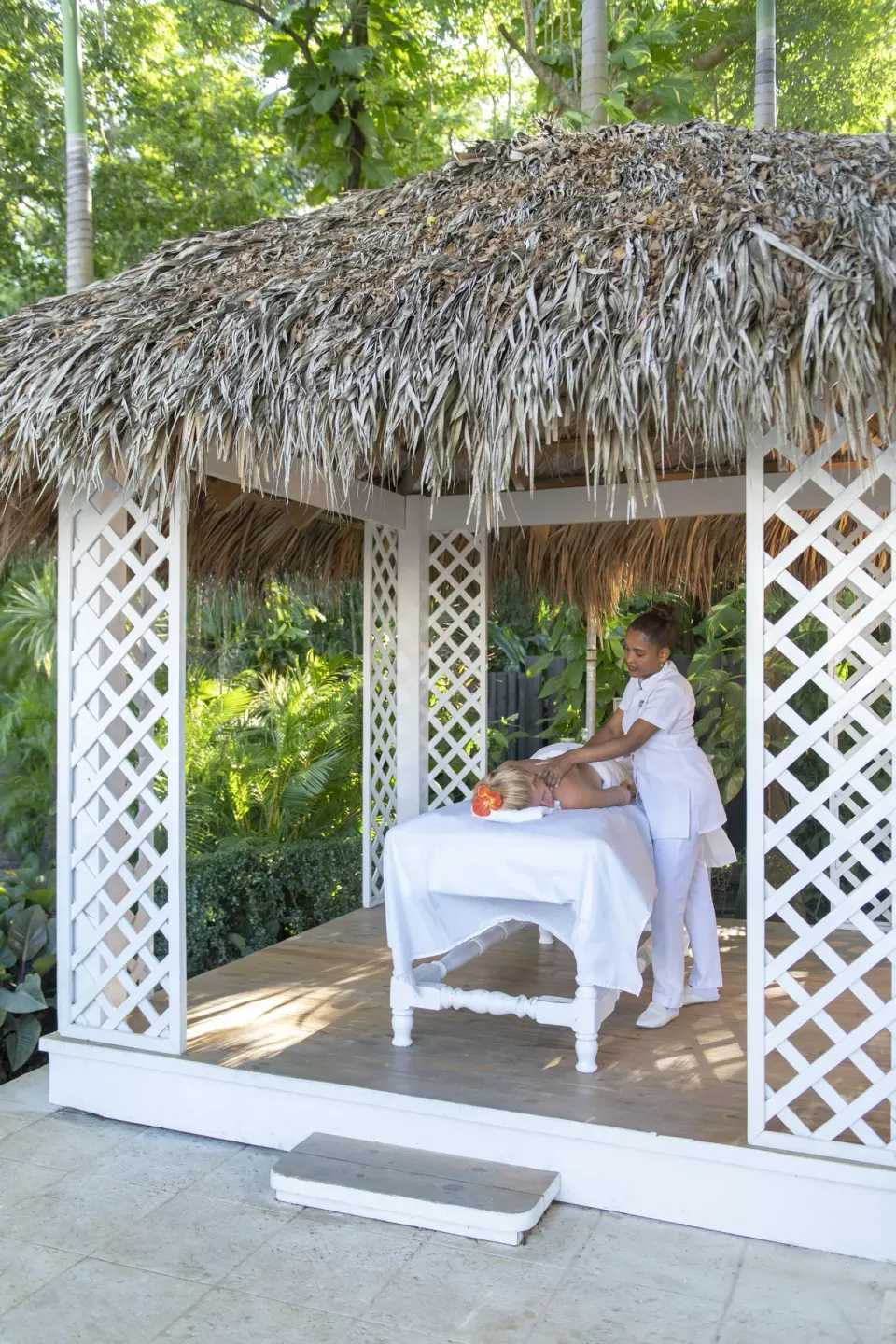 Outdoor massage in a thatched garden pavilion at Viva Heavens.