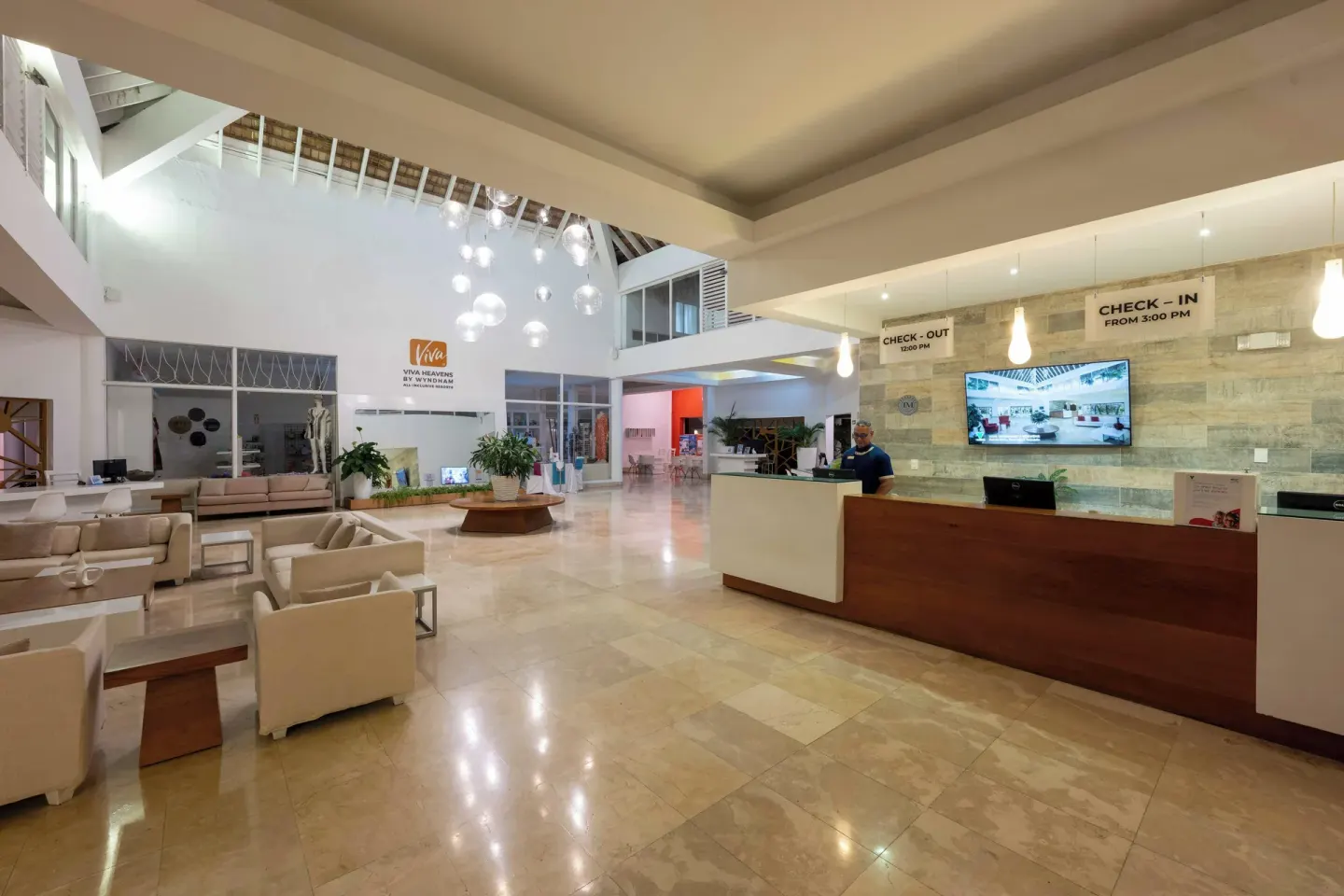 The reception desk and lounge seating are visible in the lobby at Viva Heavens.