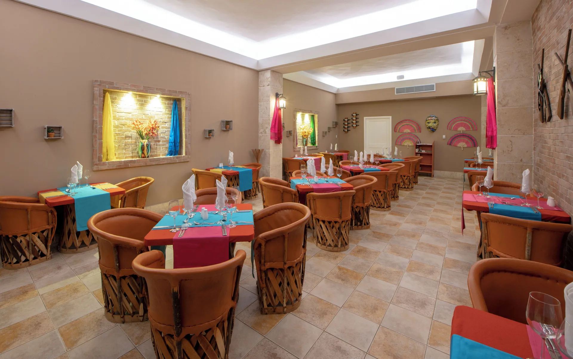 Colorful restaurant dining room with set tables at Viva Heavens.
