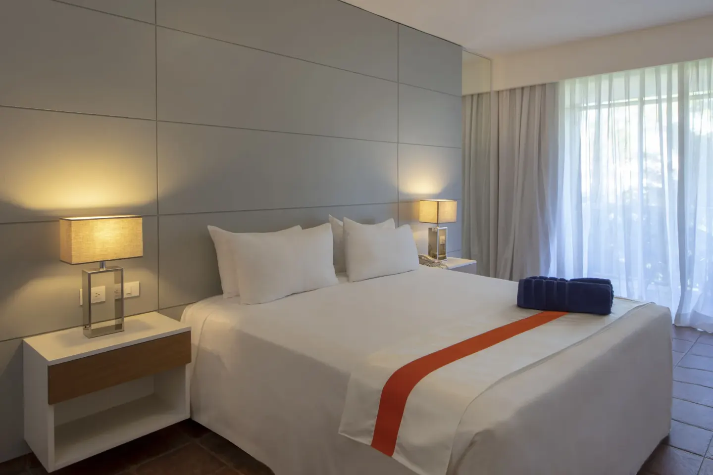 All Together Non-Smoking room with king bed and balcony curtains at Viva Heavens.