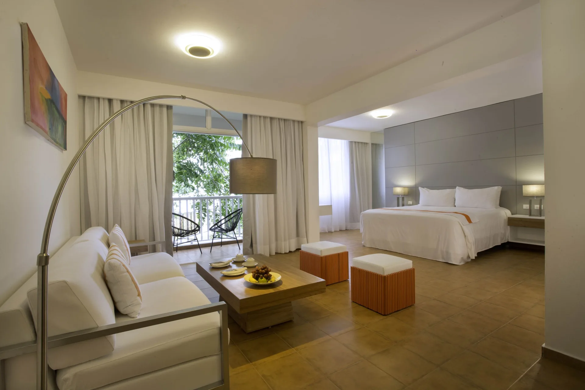 Amnesia 1 Size Bed room at Viva Heavens with a bed, sofa, coffee table, and balcony seating.