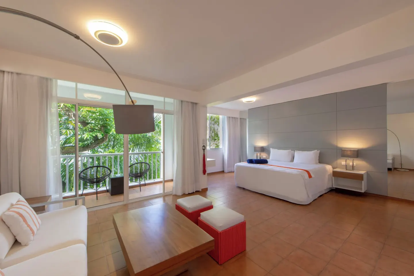 Amnesia 1 Size Bed room at Viva Heavens with a bed, lounge seating, and balcony doors to greenery.