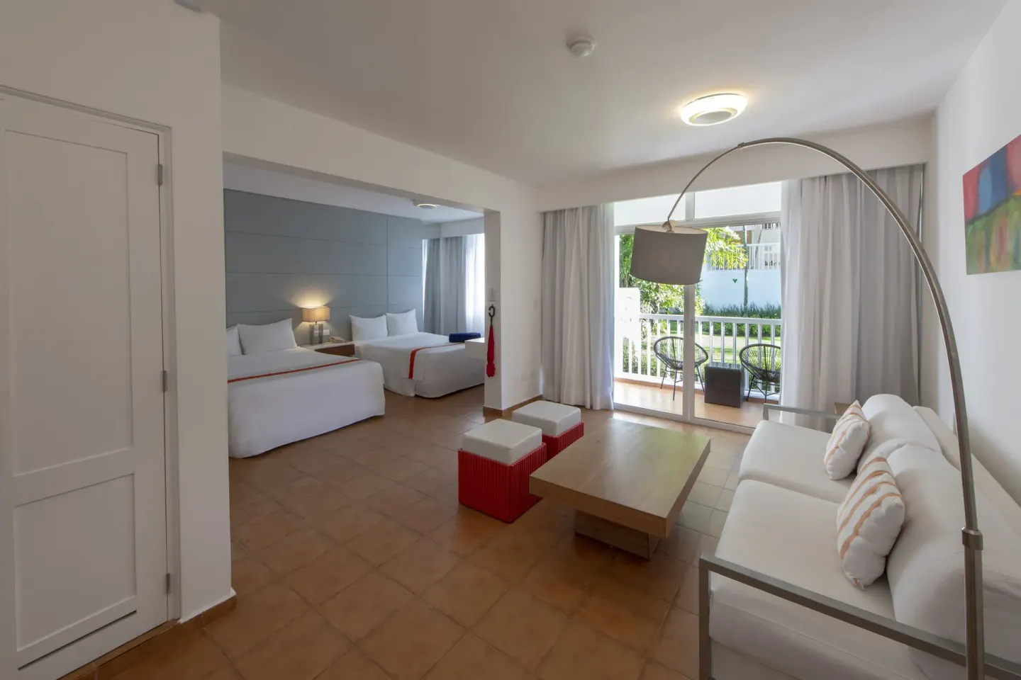 Amnesia room with two beds, sitting area, and balcony at Viva Heavens.