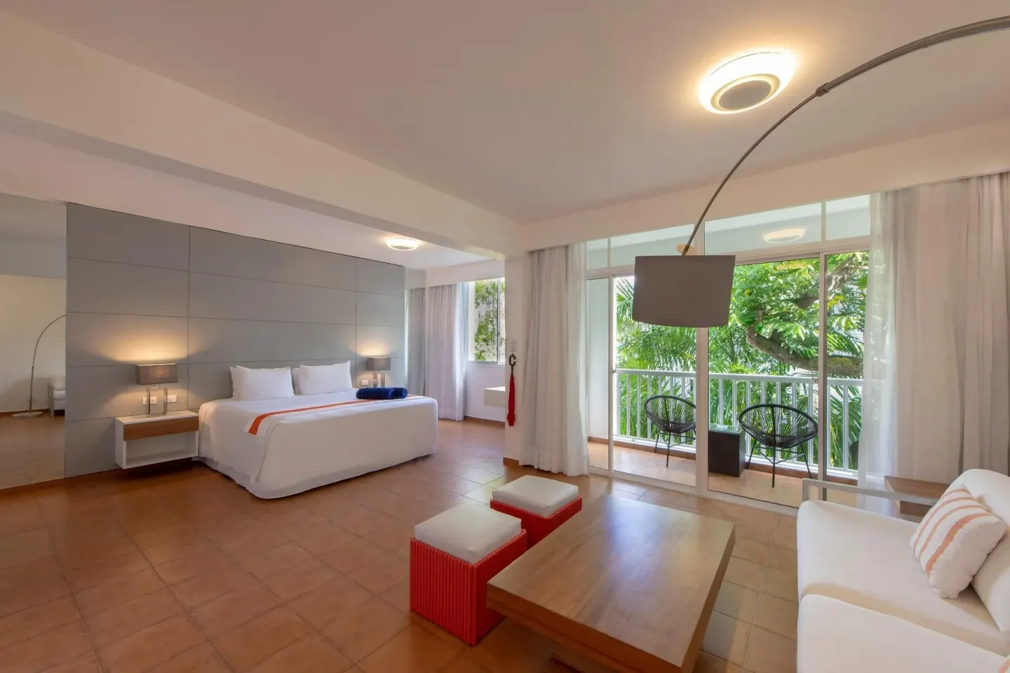 Junior Amnesia Suite bedroom and sitting area with balcony at Viva Heavens.
