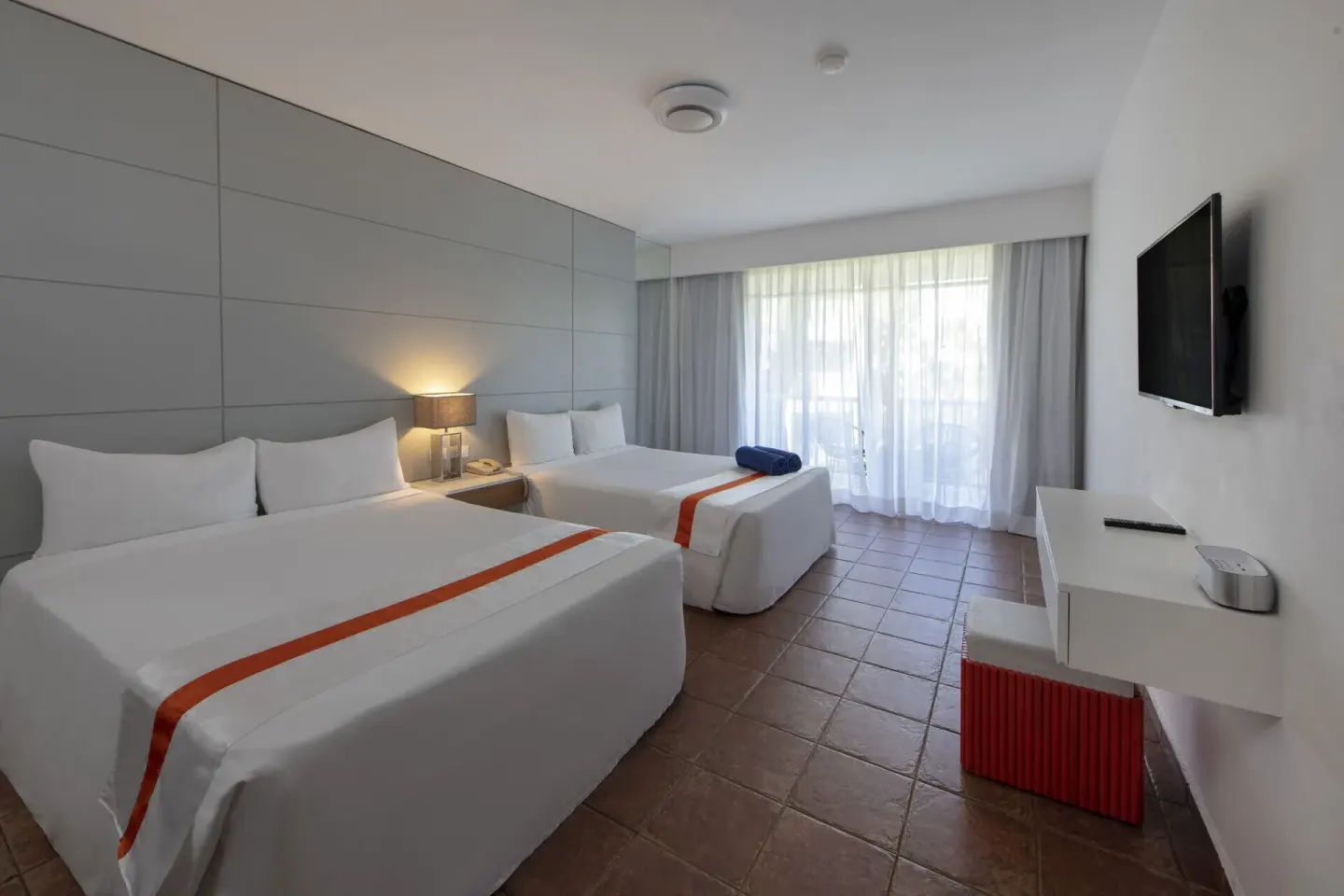 Superior Nirvana Room with two beds, desk, TV and sheer-curtained balcony at Viva Heavens.