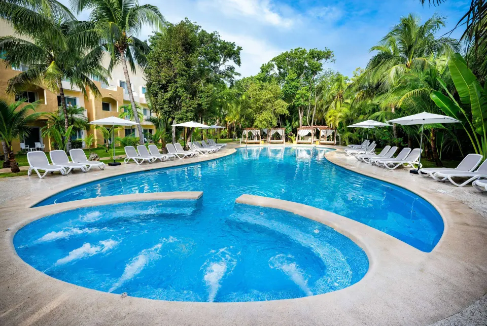Kid-friendly shallow pool area with circular jets and surrounding loungers at Viva Maya.