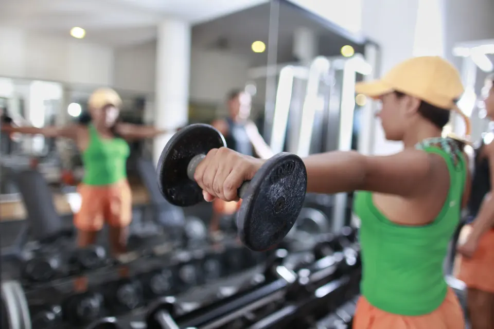 Guest lifting dumbbell in the Viva Maya fitness center