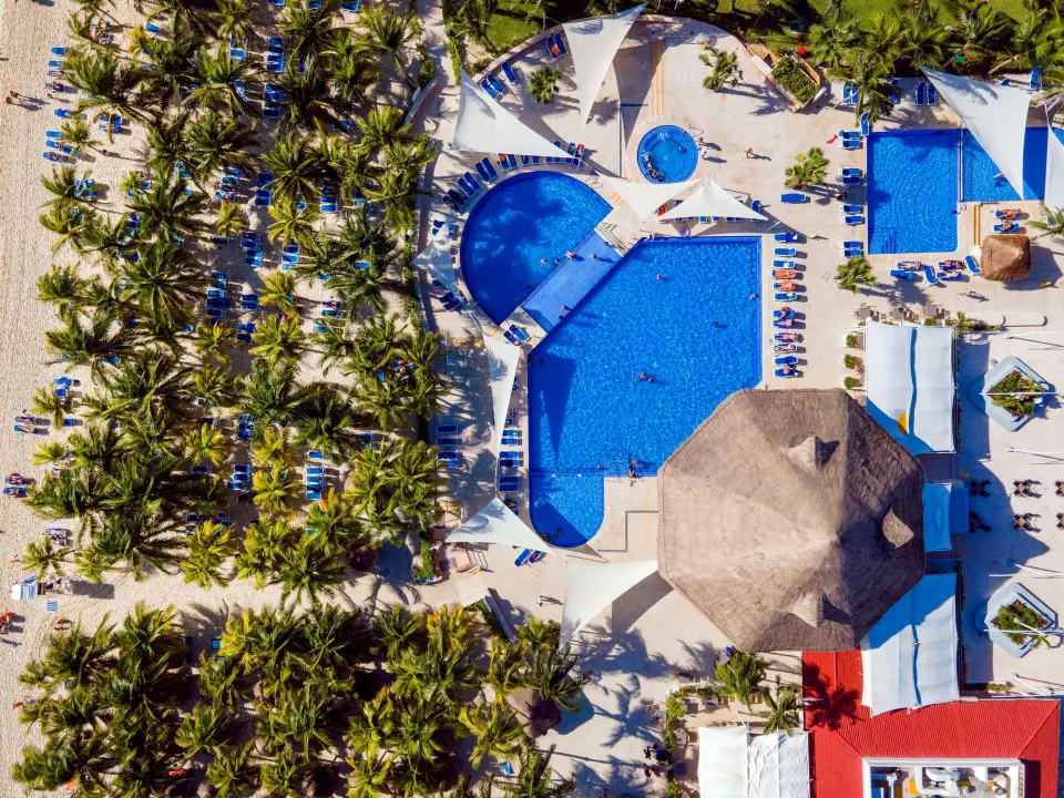 Close aerial shot of Viva Maya's main pool, swim-up areas and palapa bar.
