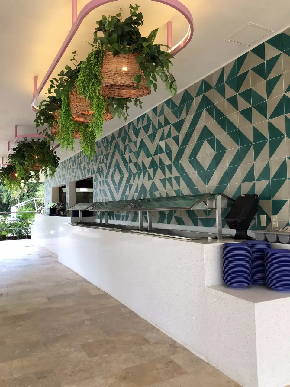 Buffet counter with geometric tile backsplash and hanging greenery at Viva Maya