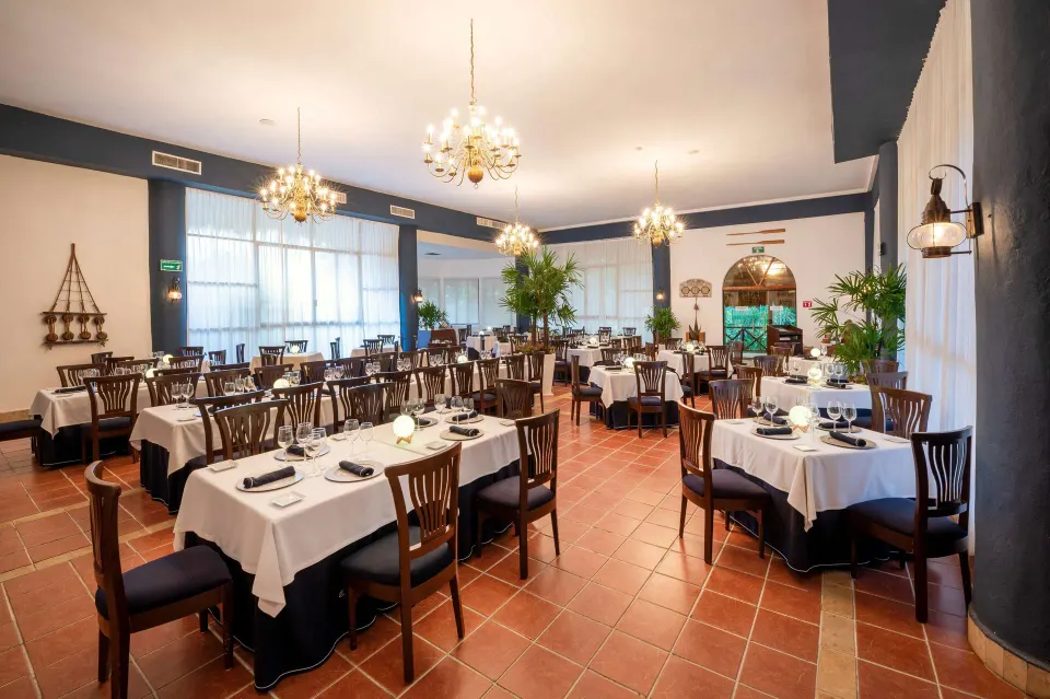 Formal indoor dining room with chandeliers at Viva Maya