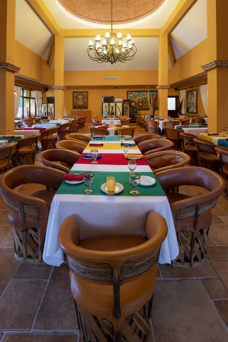 Colorful Mexican dining room with leather chairs at Viva Maya