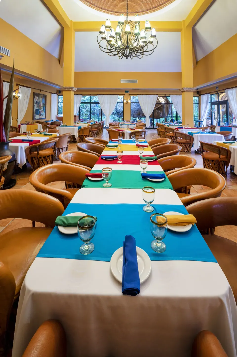 Long table with colorful runners in Hacienda dining room at Viva Maya