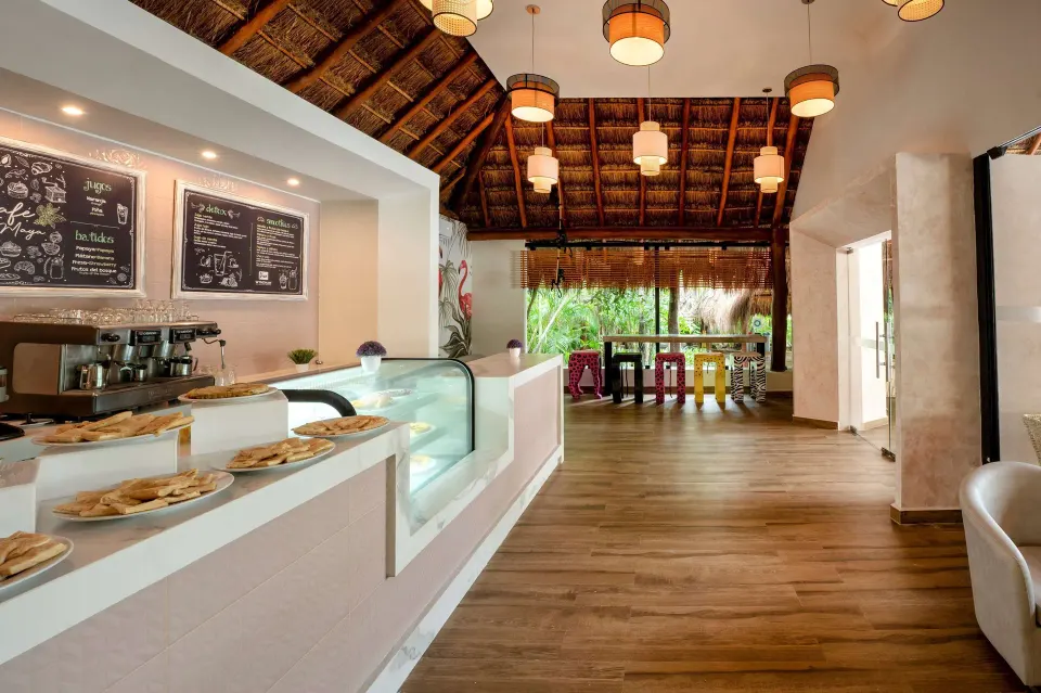 Cafe counter with pastries and palapa ceiling at Viva Maya