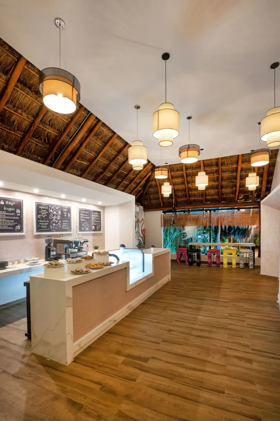 Palapa-style food counter and seating area at Viva Maya resort.