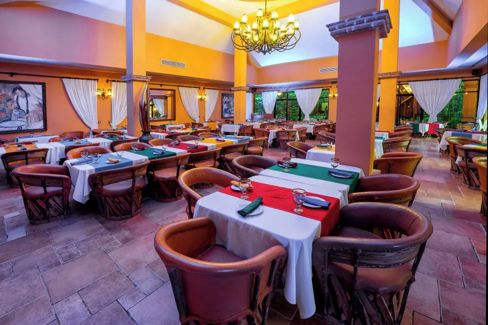Spacious indoor restaurant dining room with tables set at Viva Maya