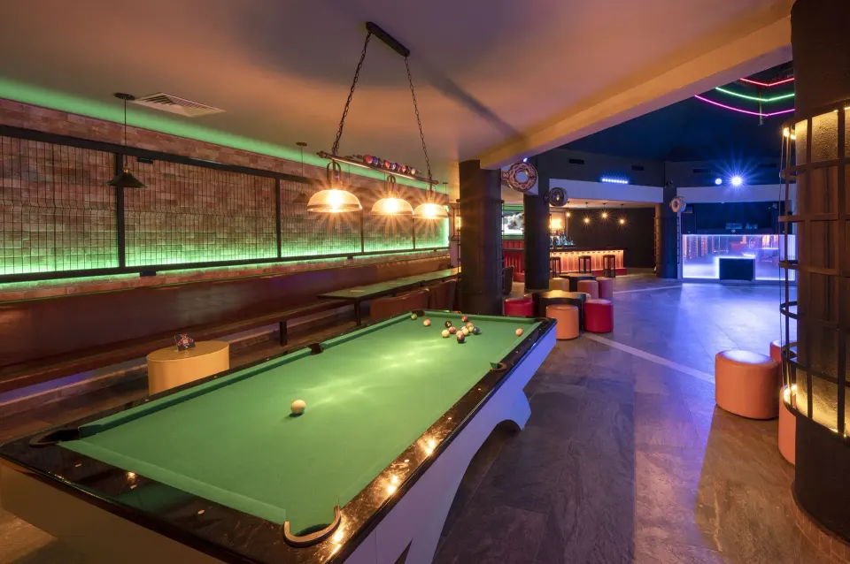 Pool table and lounge seating in the sports bar at Viva Maya