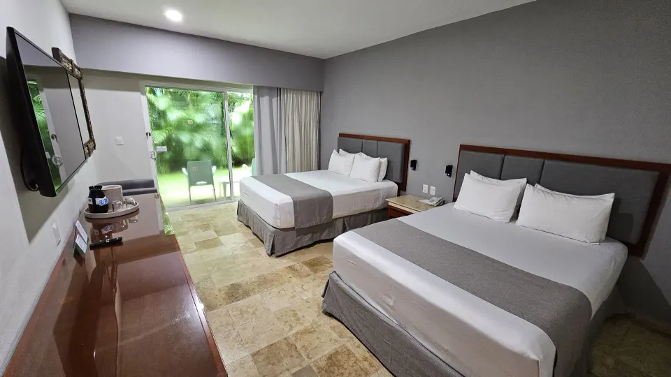 Wide view of Viva Maya with two beds and TV