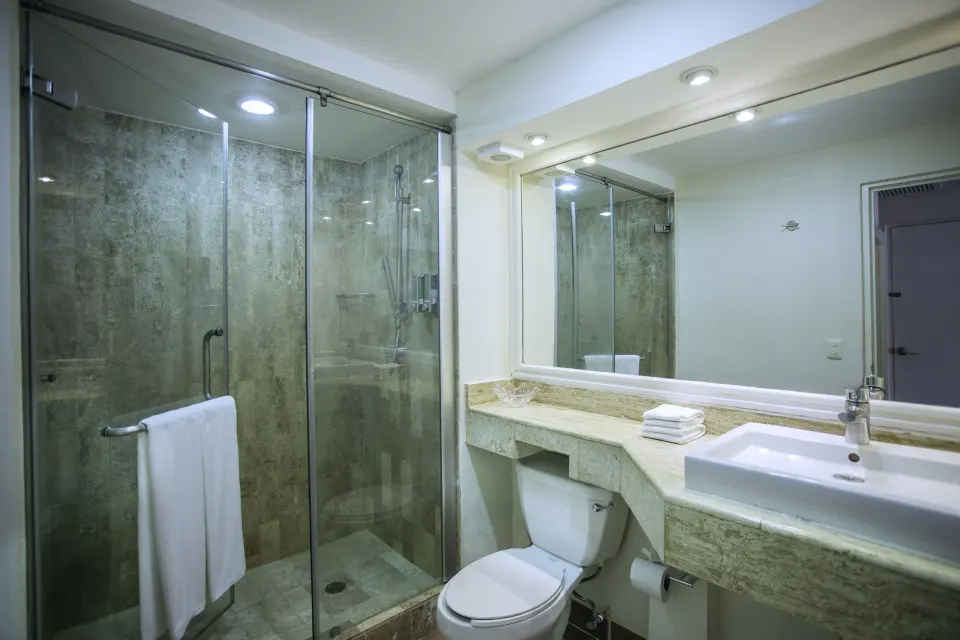 Bathroom in Superior Garden Room with glass shower and single sink at Viva Maya